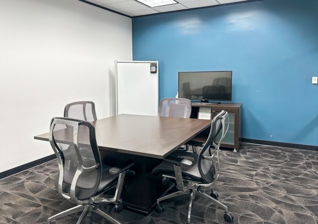 Meeting room with whiteboard and screen